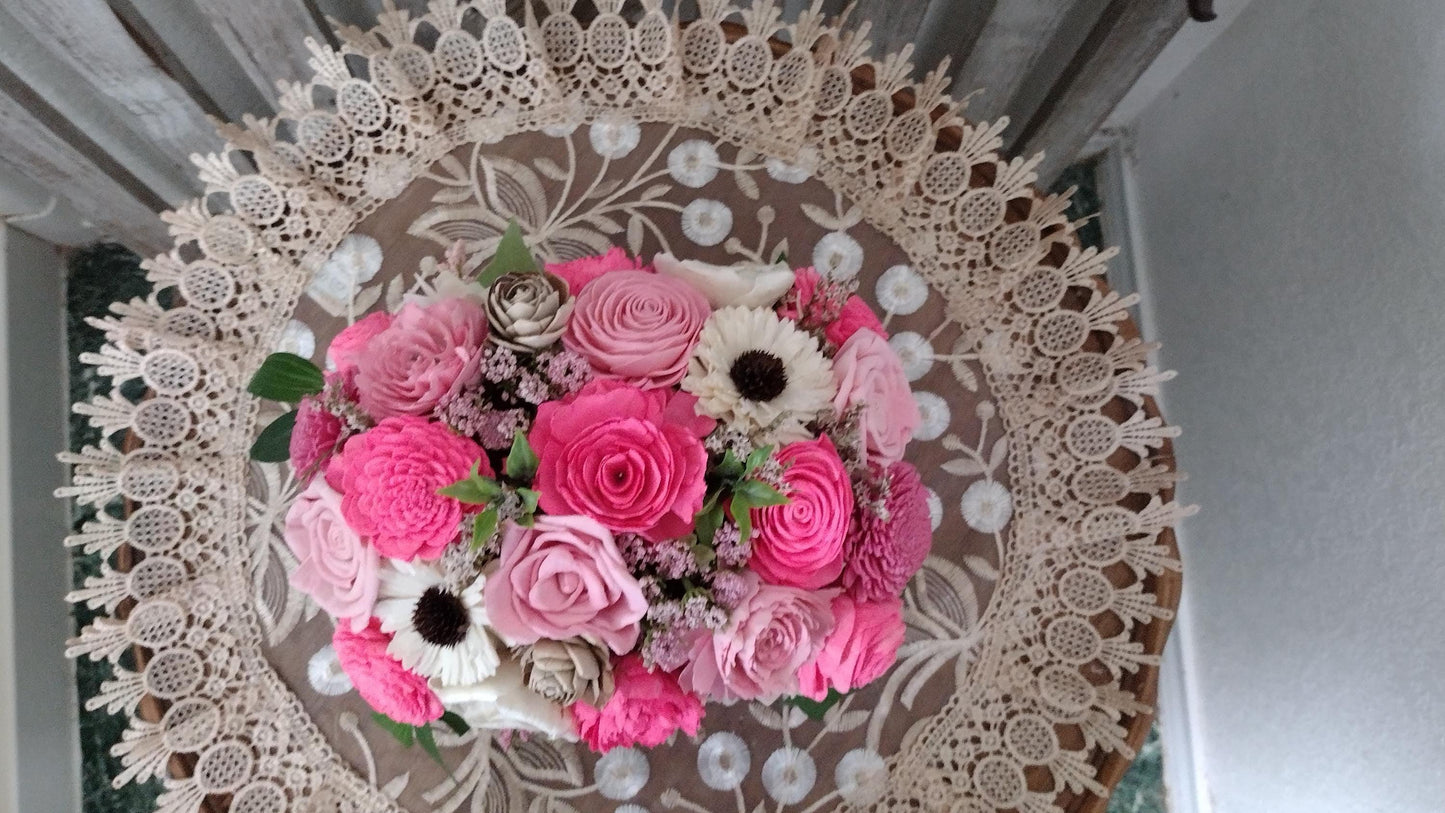 Centerpiece with hand dyed Sola flowers. Beautiful shades of pink wooden florals in a galvanized container